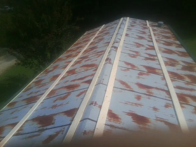 Rusted metal roof panels with new wood purlins before replacement — Storm Damage Roof Repair in Brazil by Roofing Brothers